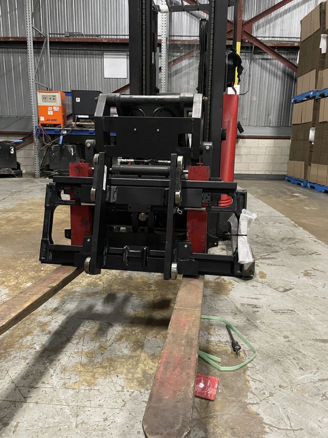 Forks on a red forklift.