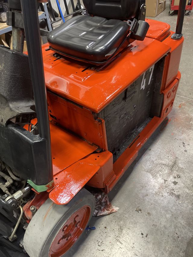Seat and body for an orange fork lift.